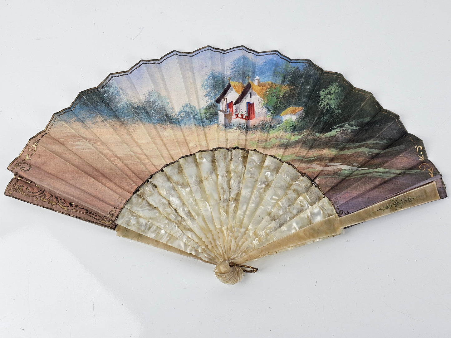 Decorative fan with scenic painting on a white background