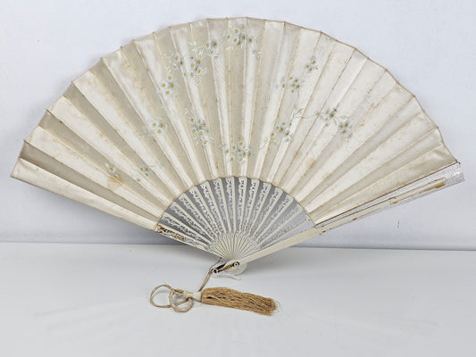 Traditional folding fan with decorative design on a white background