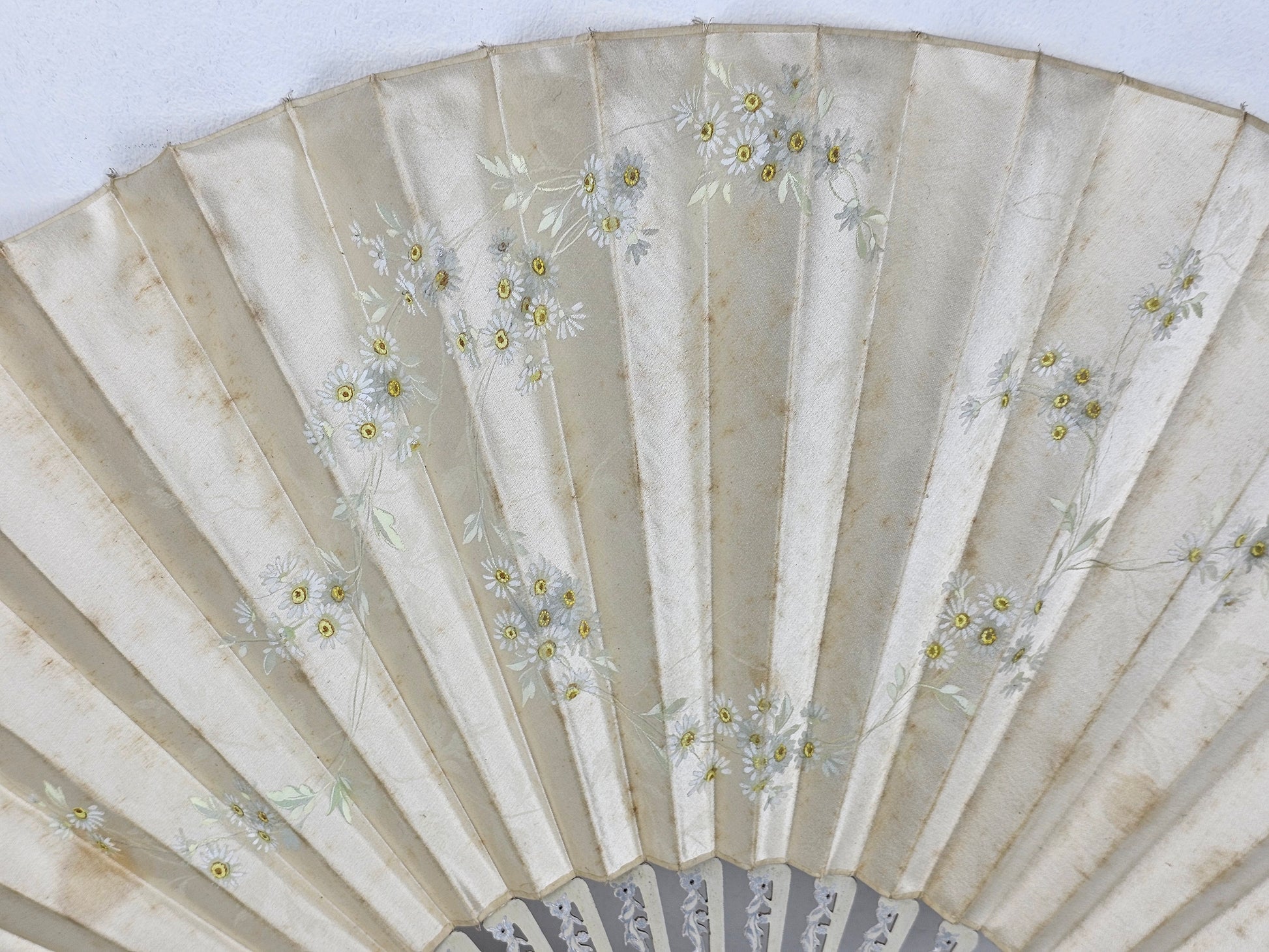Decorative fan with floral patterns on a white background