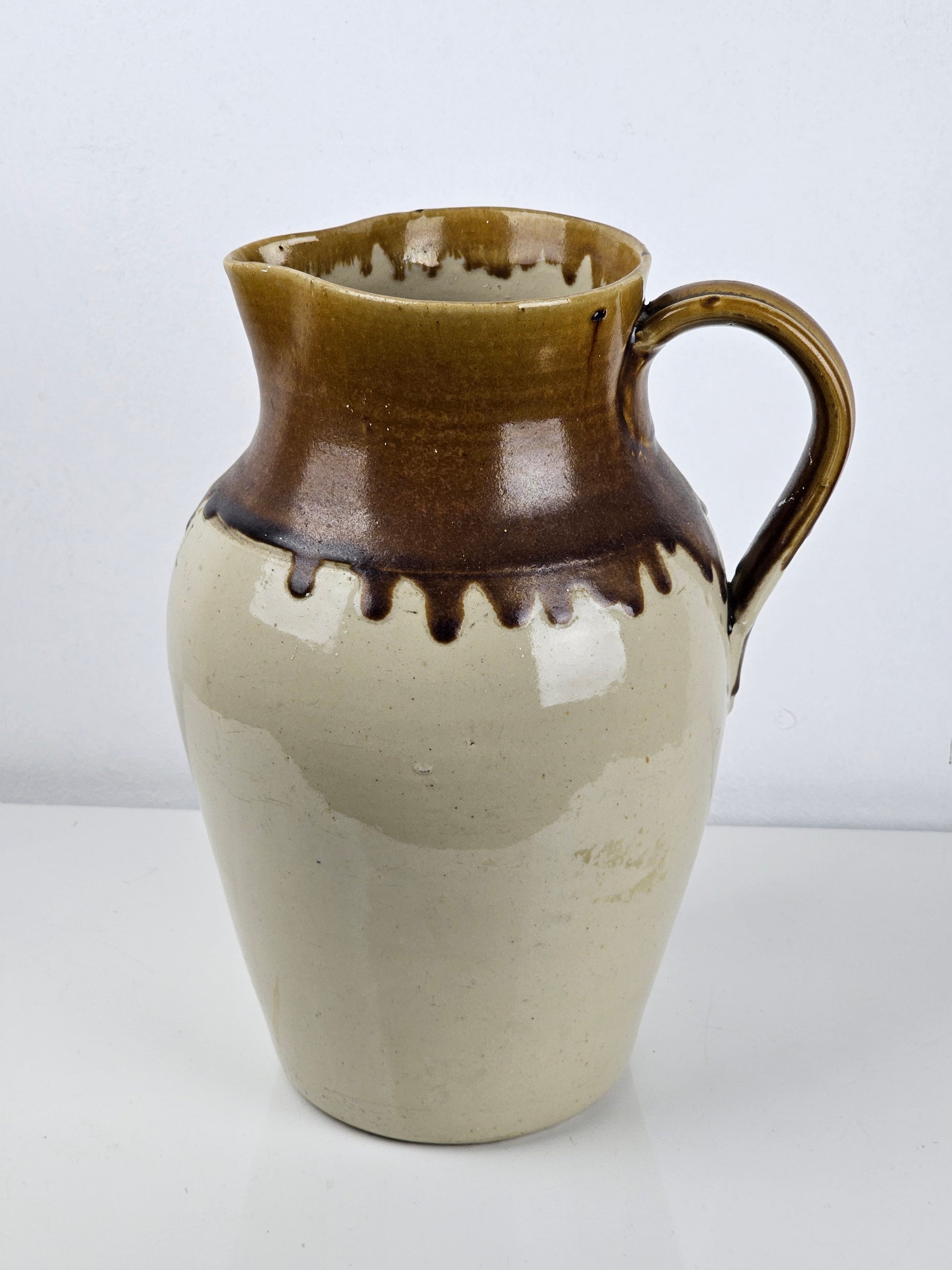 Ceramic vase with brown and beige glaze on a white background